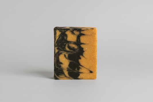 Turmeric Charcoal Soap with light gray background